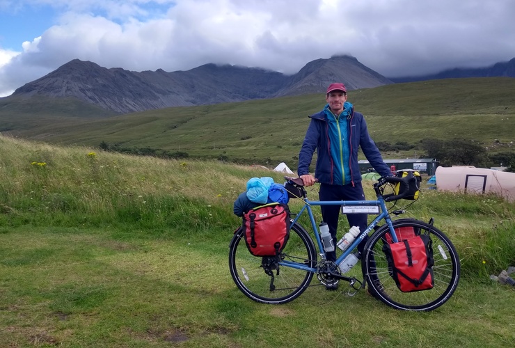 Oli Warlow and his bike, against a backdrop of the Cuillin Ridge