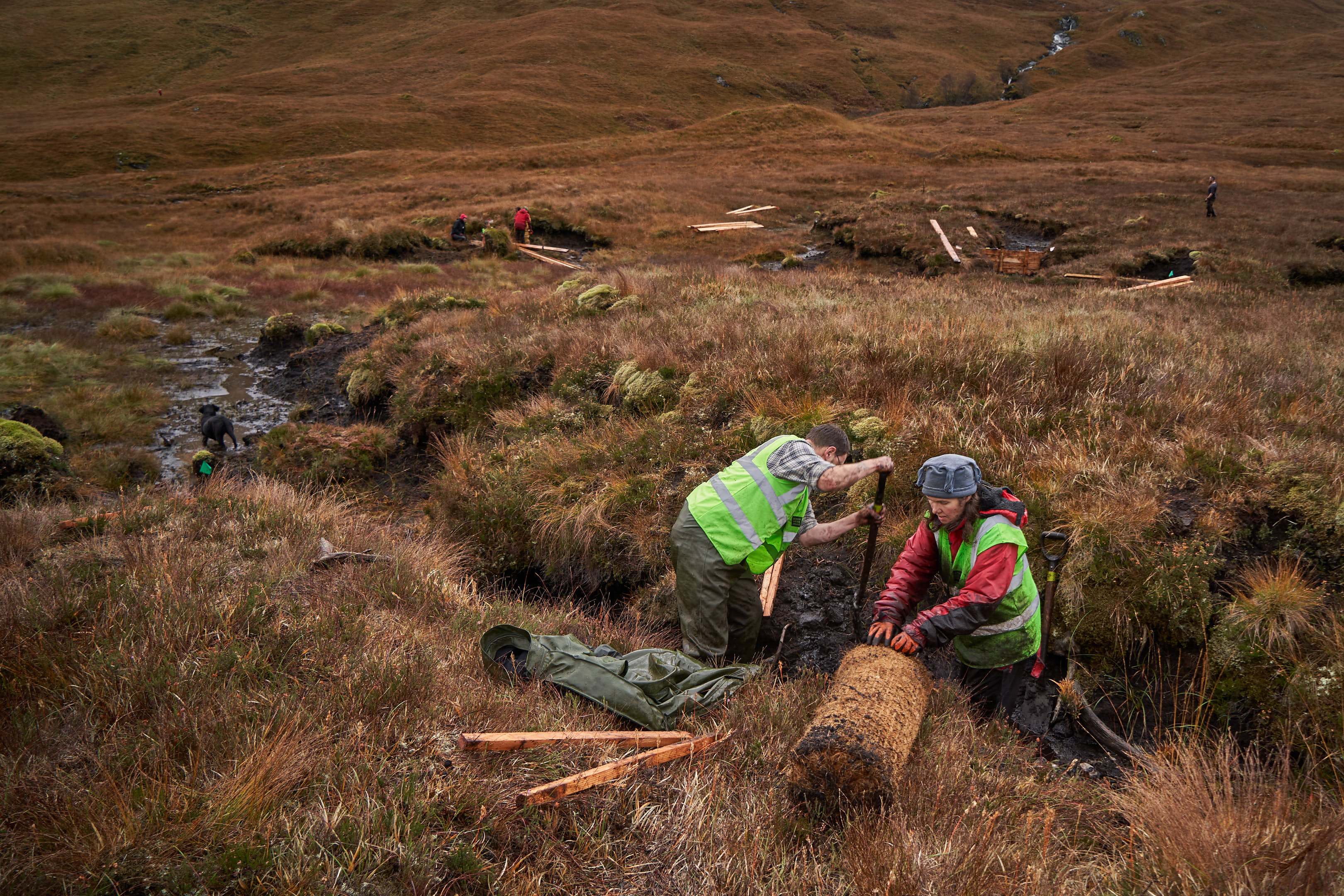 Volunteers installing a coire log to help raise the water level