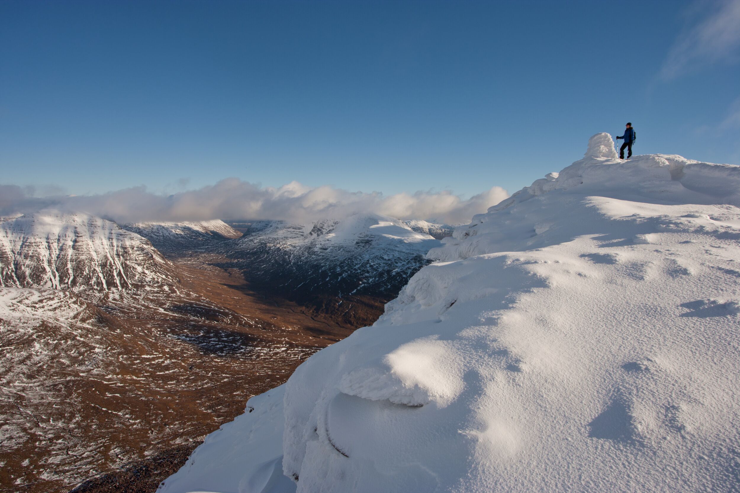 Hill walker on the summit of Tom na Gruagaich (922m) in winter, Beinn Alligin, Torridon, Scotland © Mark Hamblin / 2020Vision