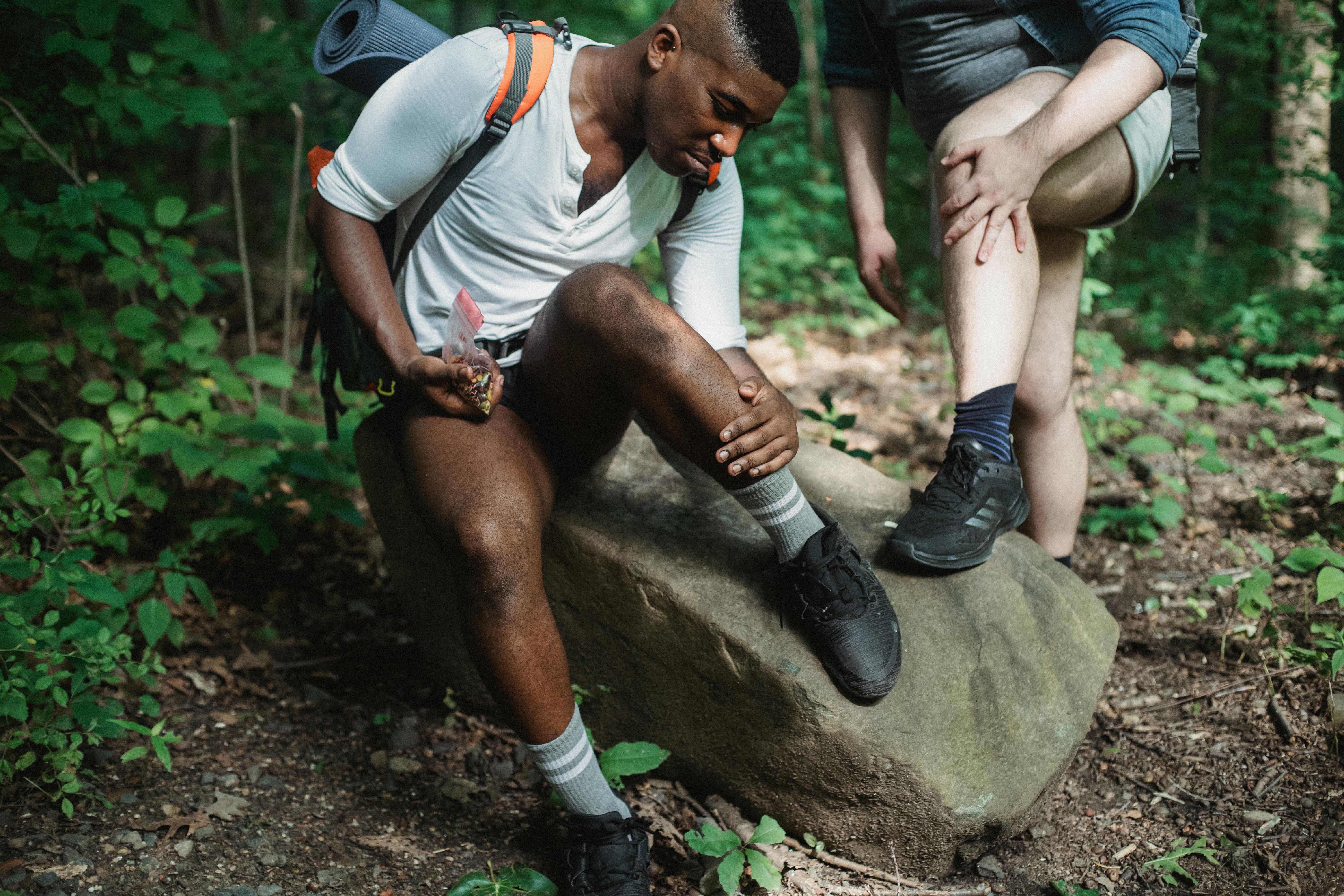 Friends checking for ticks during hike in forest - Kamaji Ogino (Pexels Stock Photos)
